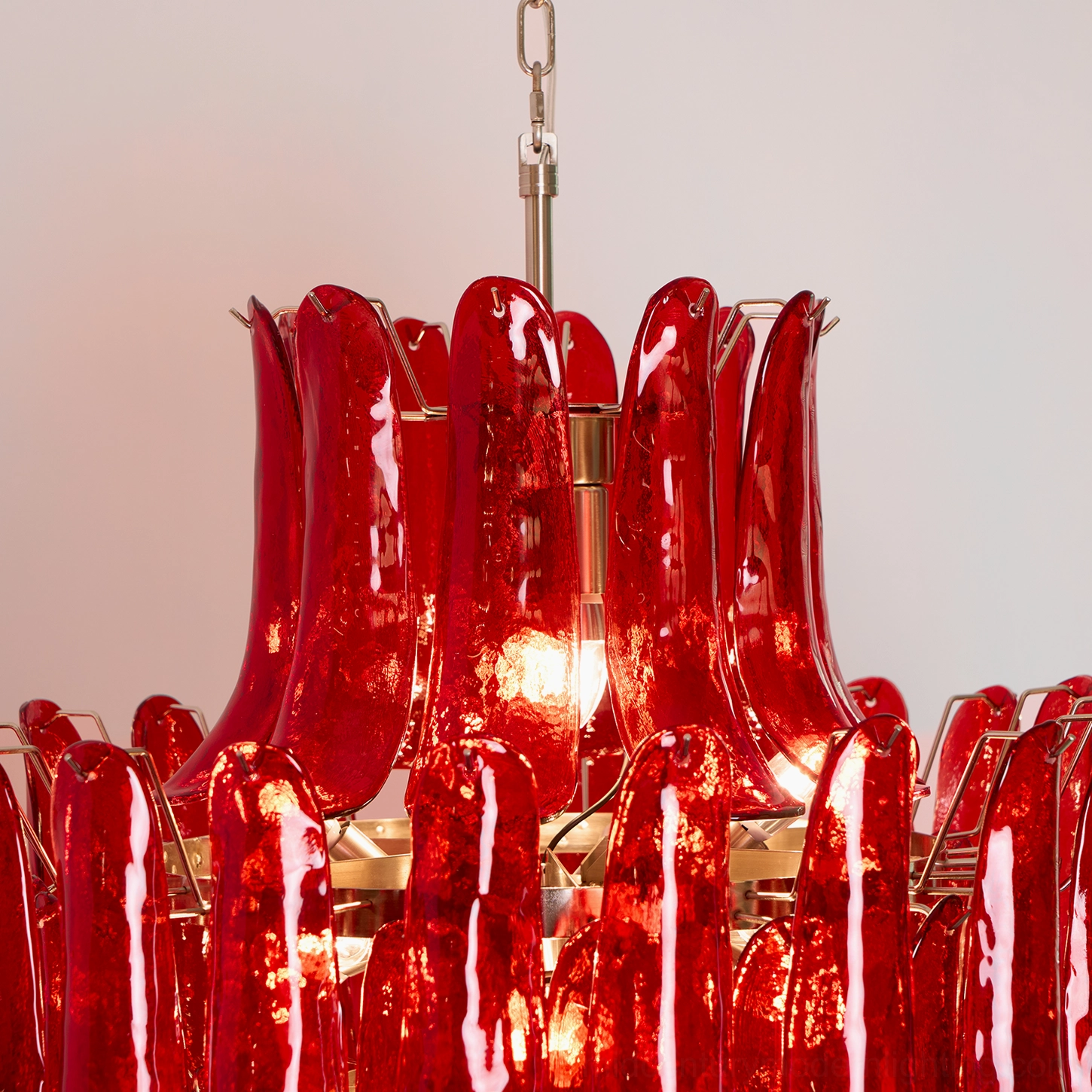 Top-down close-up view of Murano glass chandelier showing stacked red glass petals and exposed E14 bulb sockets arrangement