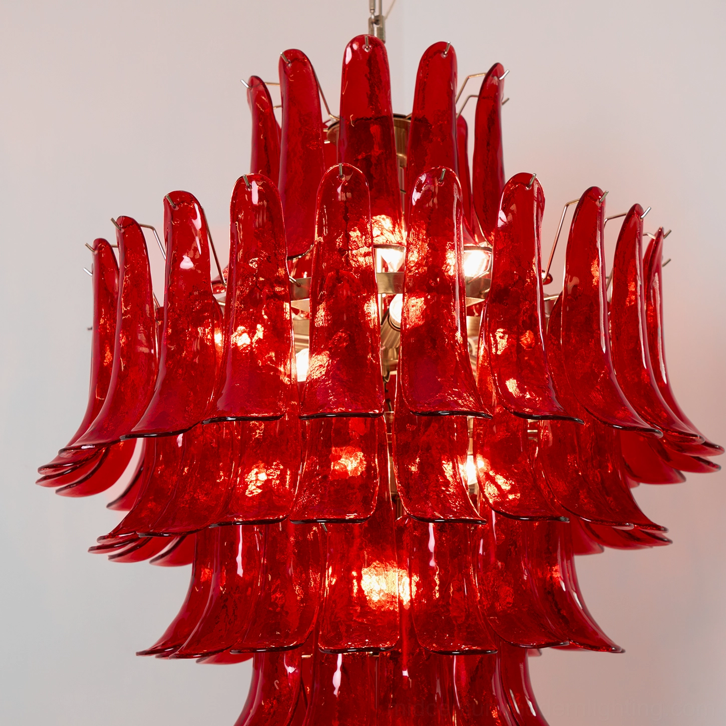 Side profile of Murano glass chandelier displaying curved cascading petals and elegant gold metal suspension hardware