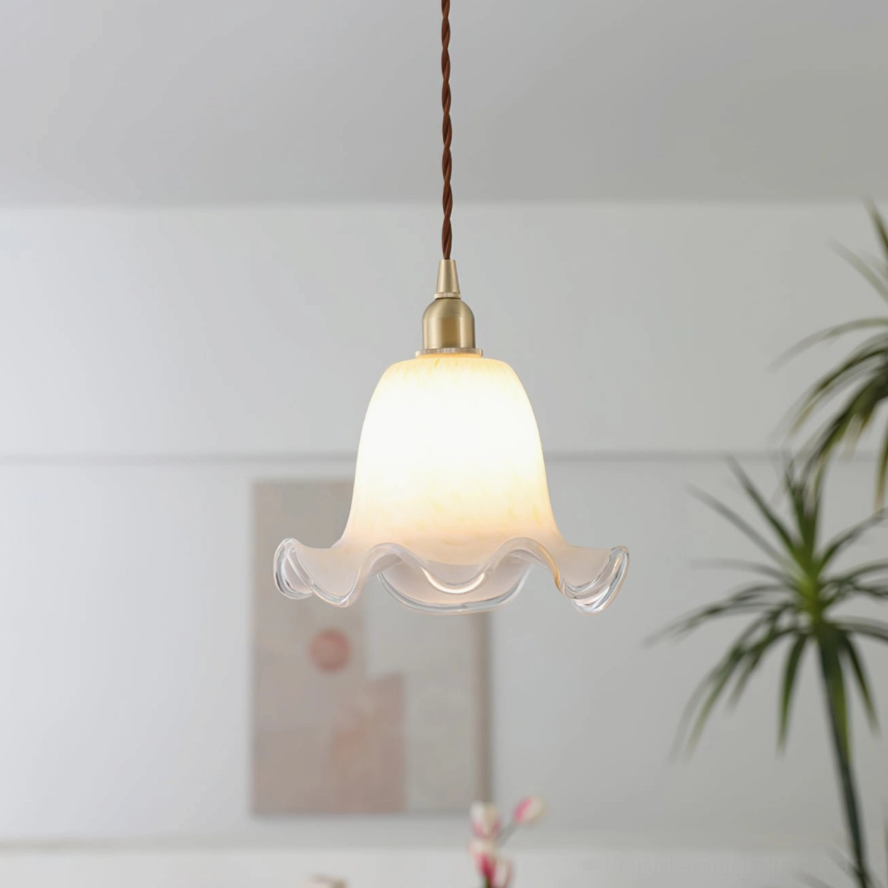 Handcrafted glass pendant lamp showcasing ruffled edge design in minimalist modern living space
