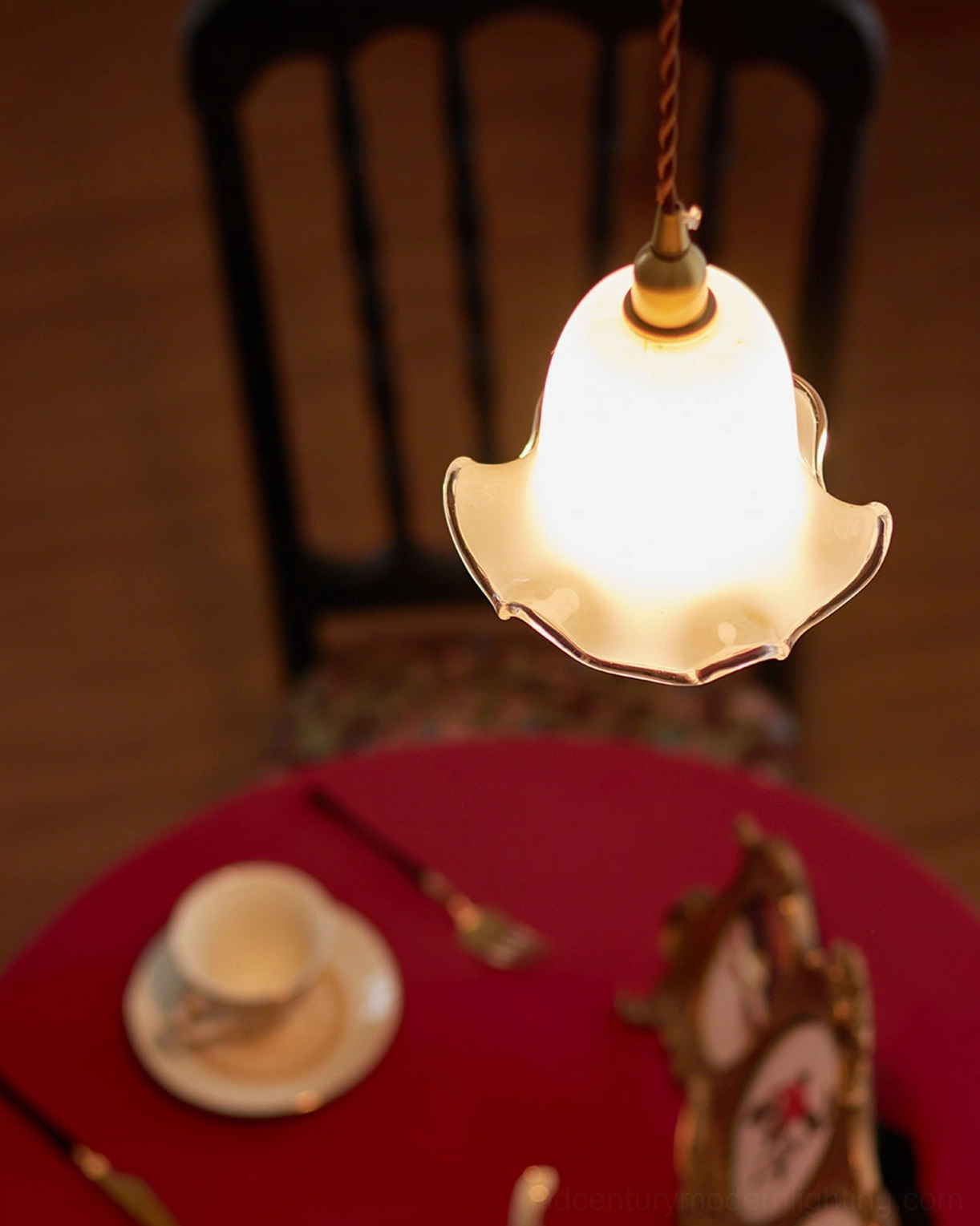 Murano glass pendant fixture in vintage entryway with wooden cabinet and decorative ornaments