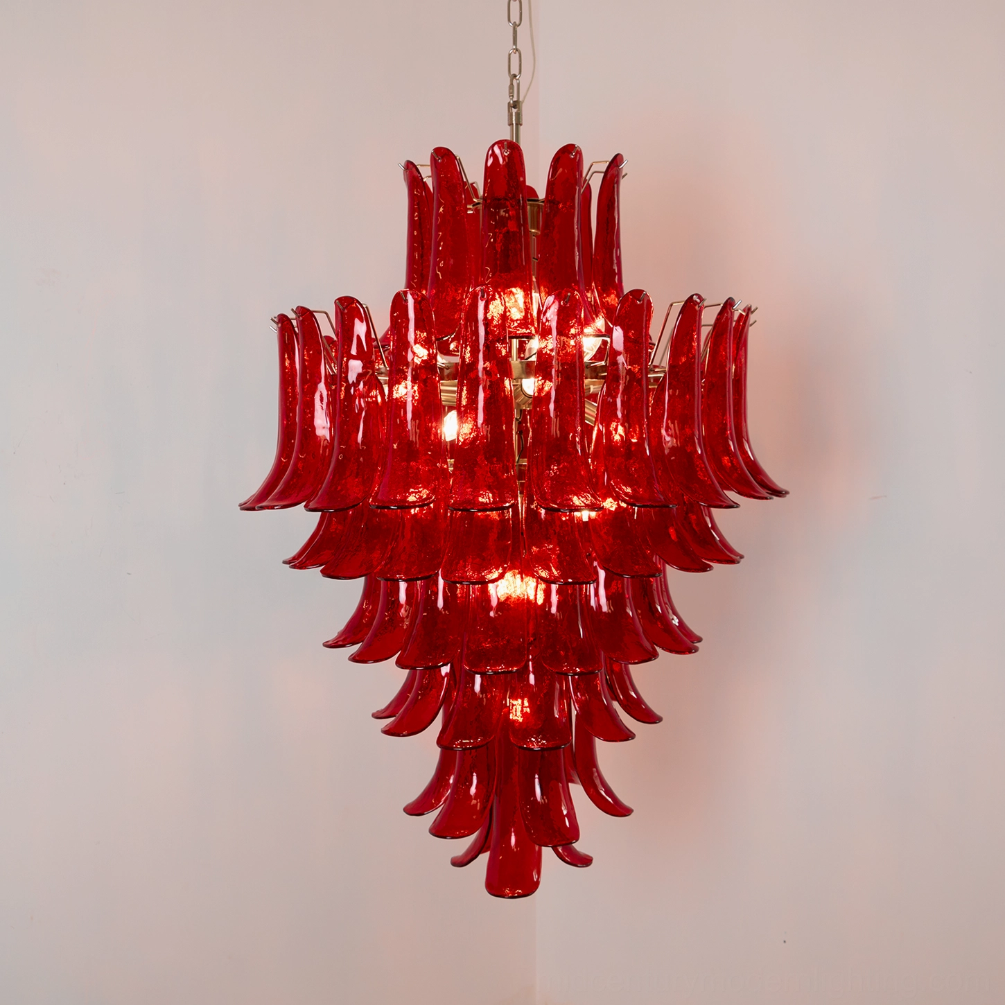 Detailed view of Murano red glass chandelier showing petal arrangement, light transmission through colored glass, and premium metal framework