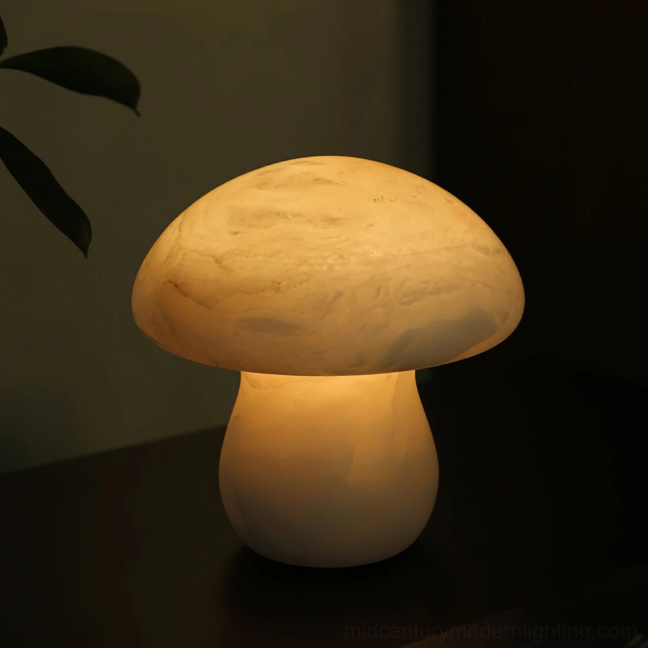 Glowing mushroom alabaster lamp on wooden table creating warm ambient light in modern minimalist bedroom or living room setting