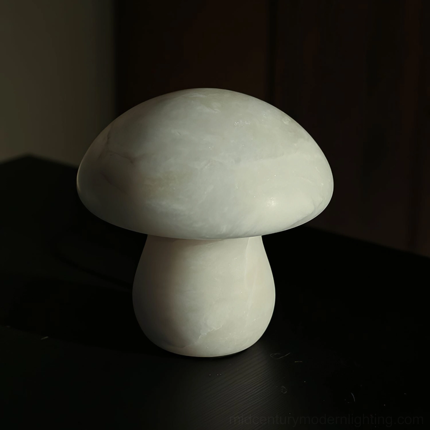 Three-quarter side view of mushroom alabaster table lamp with rounded smooth shape and uniform off-white finish