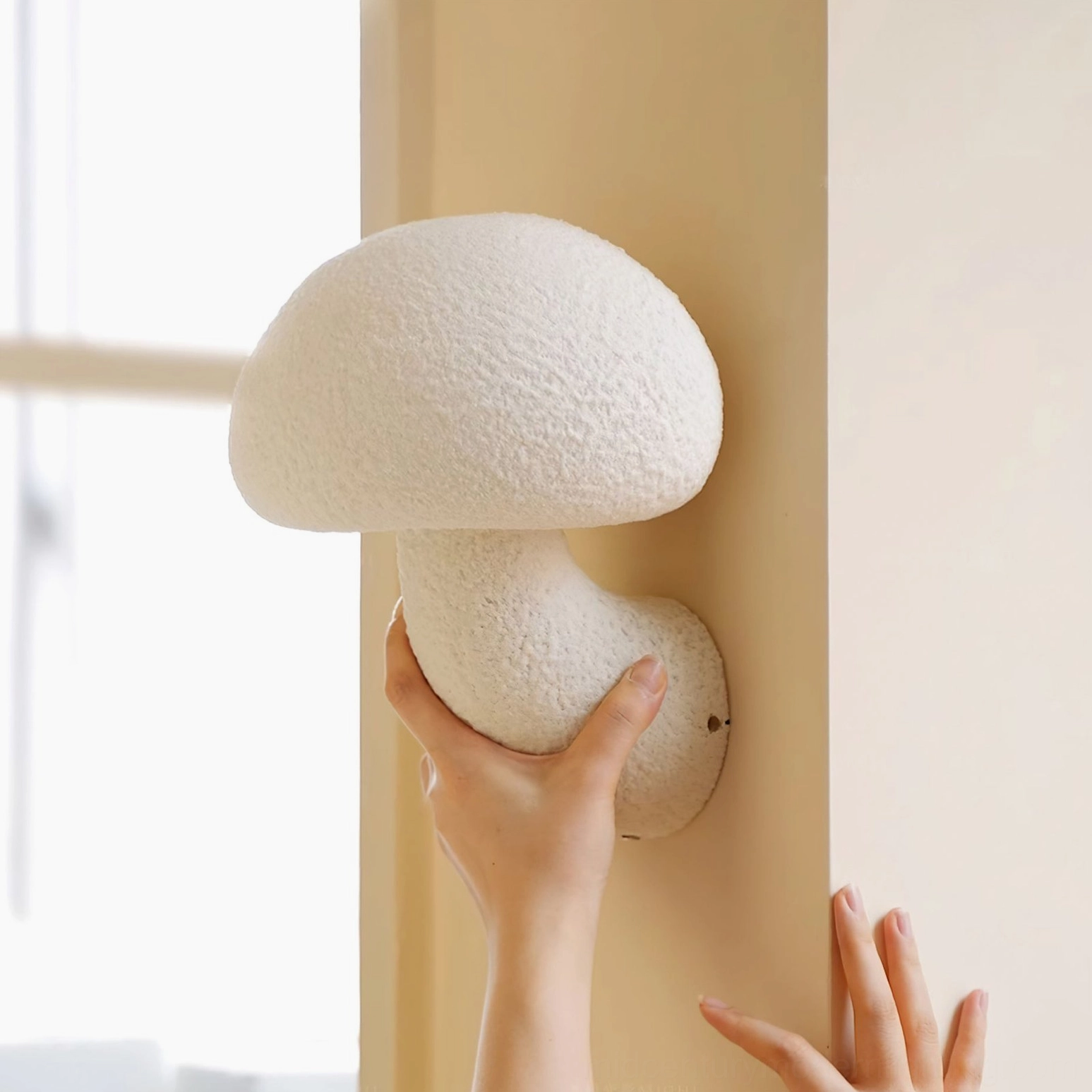 Mushroom resin wall lamp with human hand for scale comparison - installation and size reference