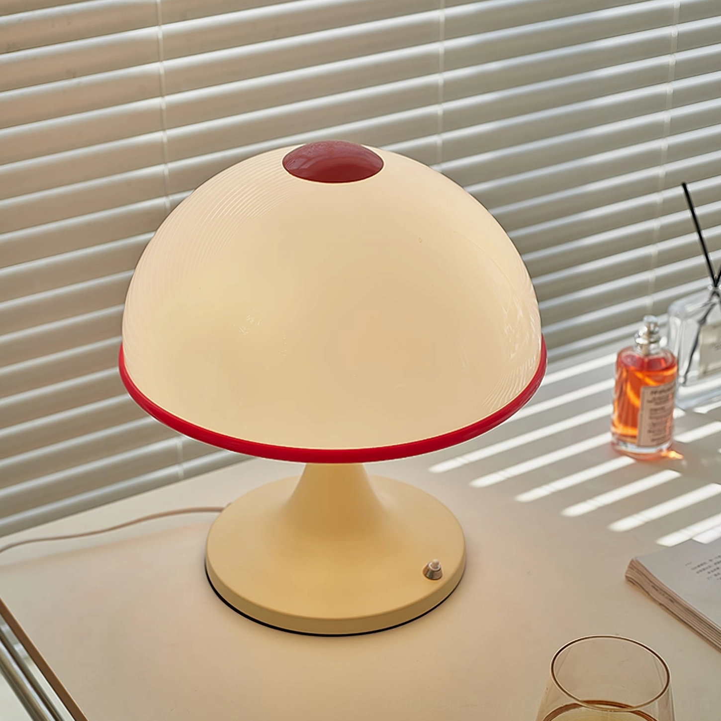 Mid-century mushroom lamp on desk with window blinds, natural daylight with striped shadows
