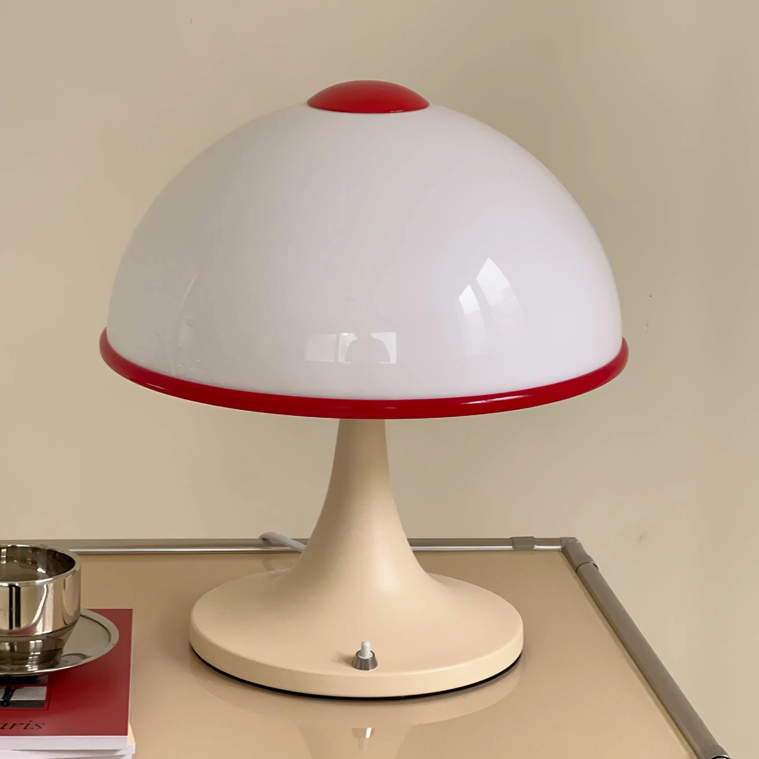 Minimalist mushroom lamp with glossy cream and red finish on metal side table