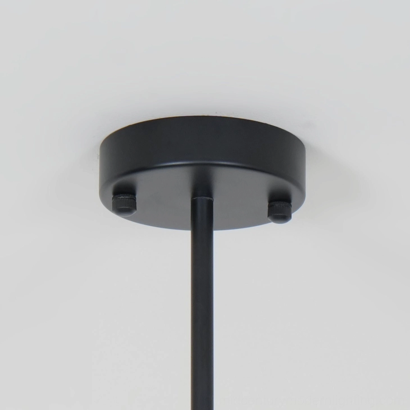 Myrna arc pendant lighting fixture with gold and black metal finish, design detail