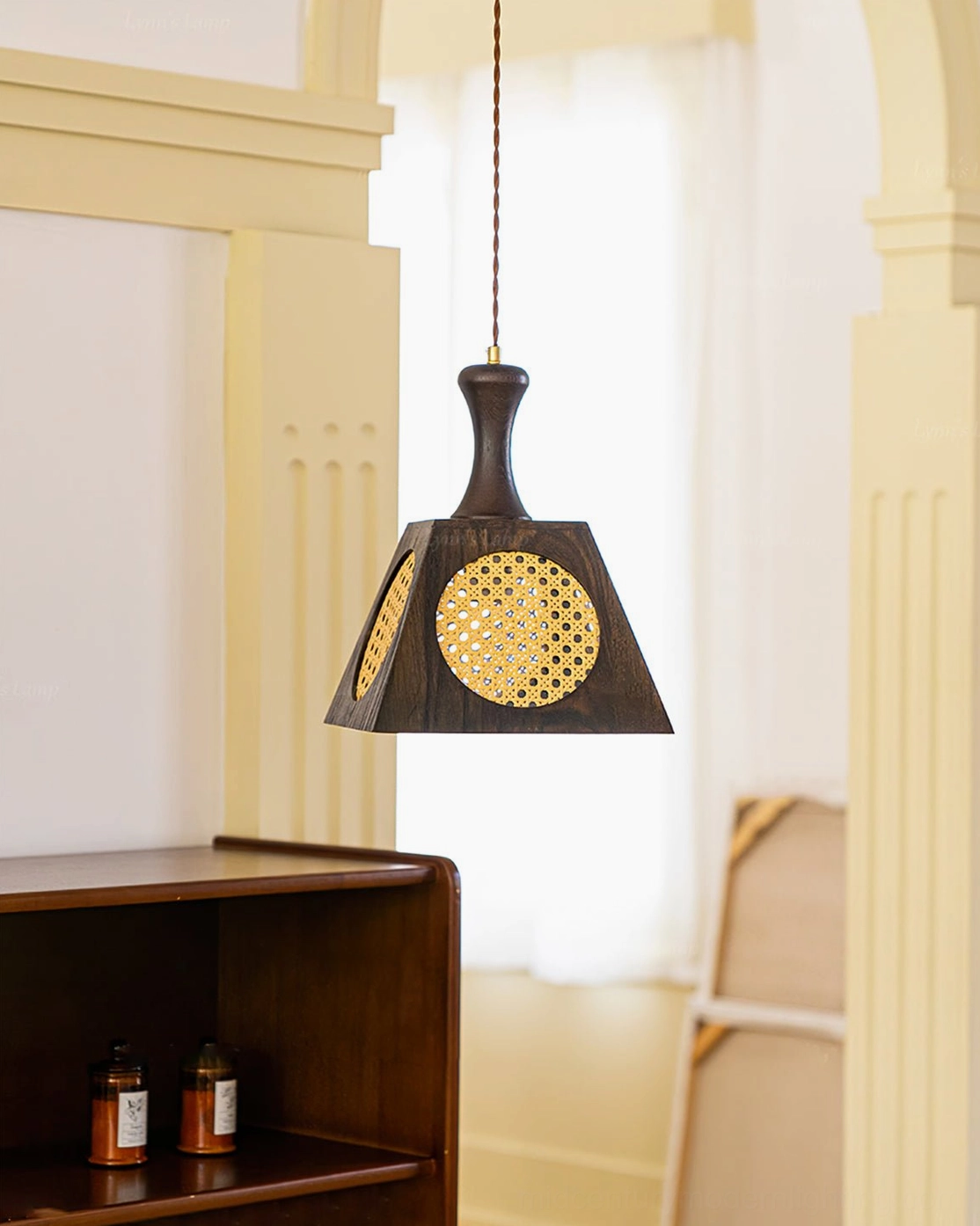 Mysore rattan pendant lamp hanging in bright vintage hallway with warm ambient glow, showcasing mid-century modern design in home setting