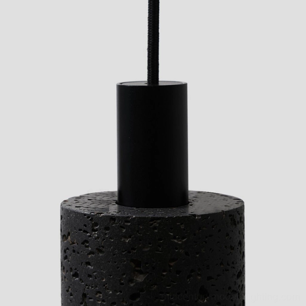 Close-up detail of N Stone Pendant Lamp base showing textured black lava stone and metal collar joint