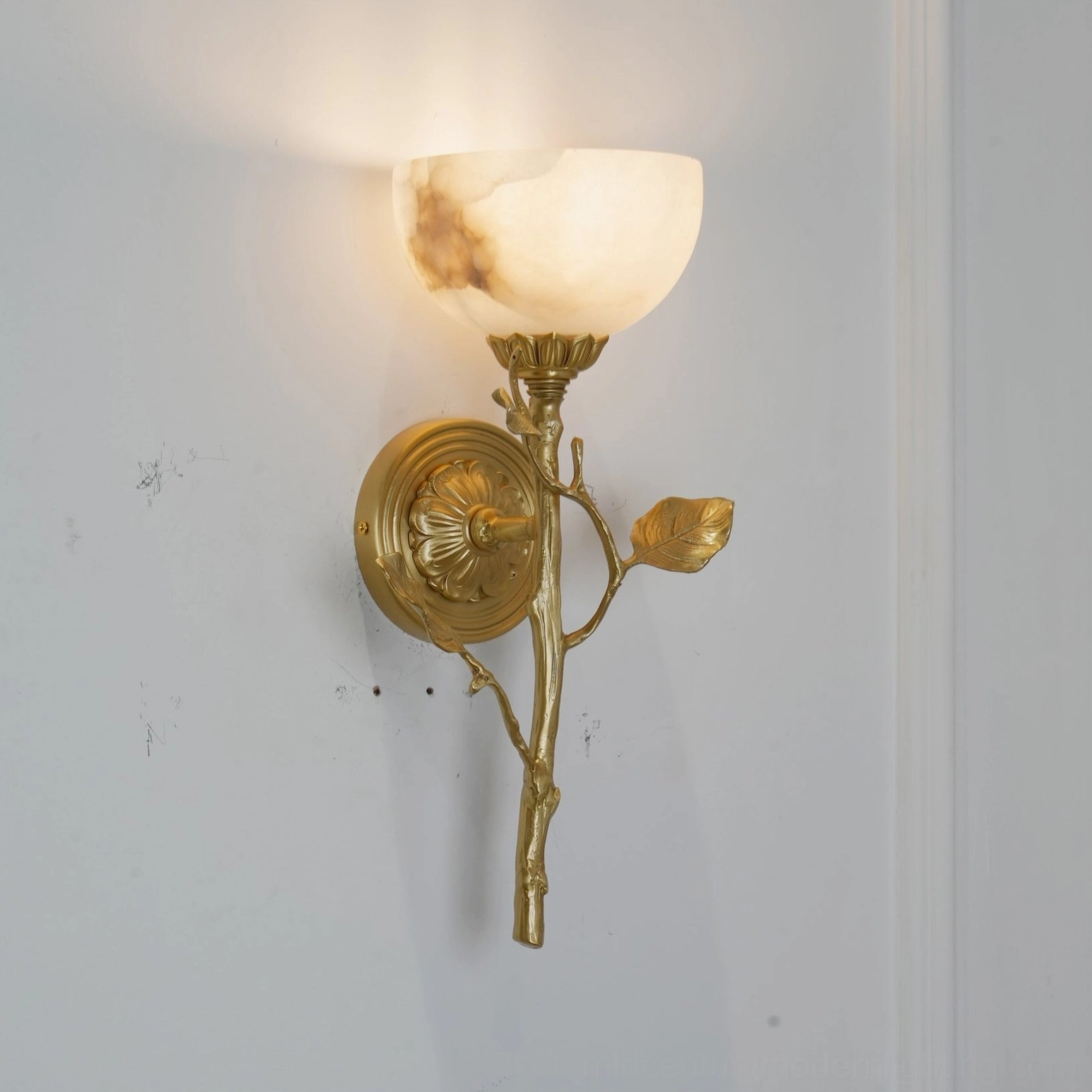 Natalia frosted alabaster sconce with brass decorative elements in contemporary interior design setting