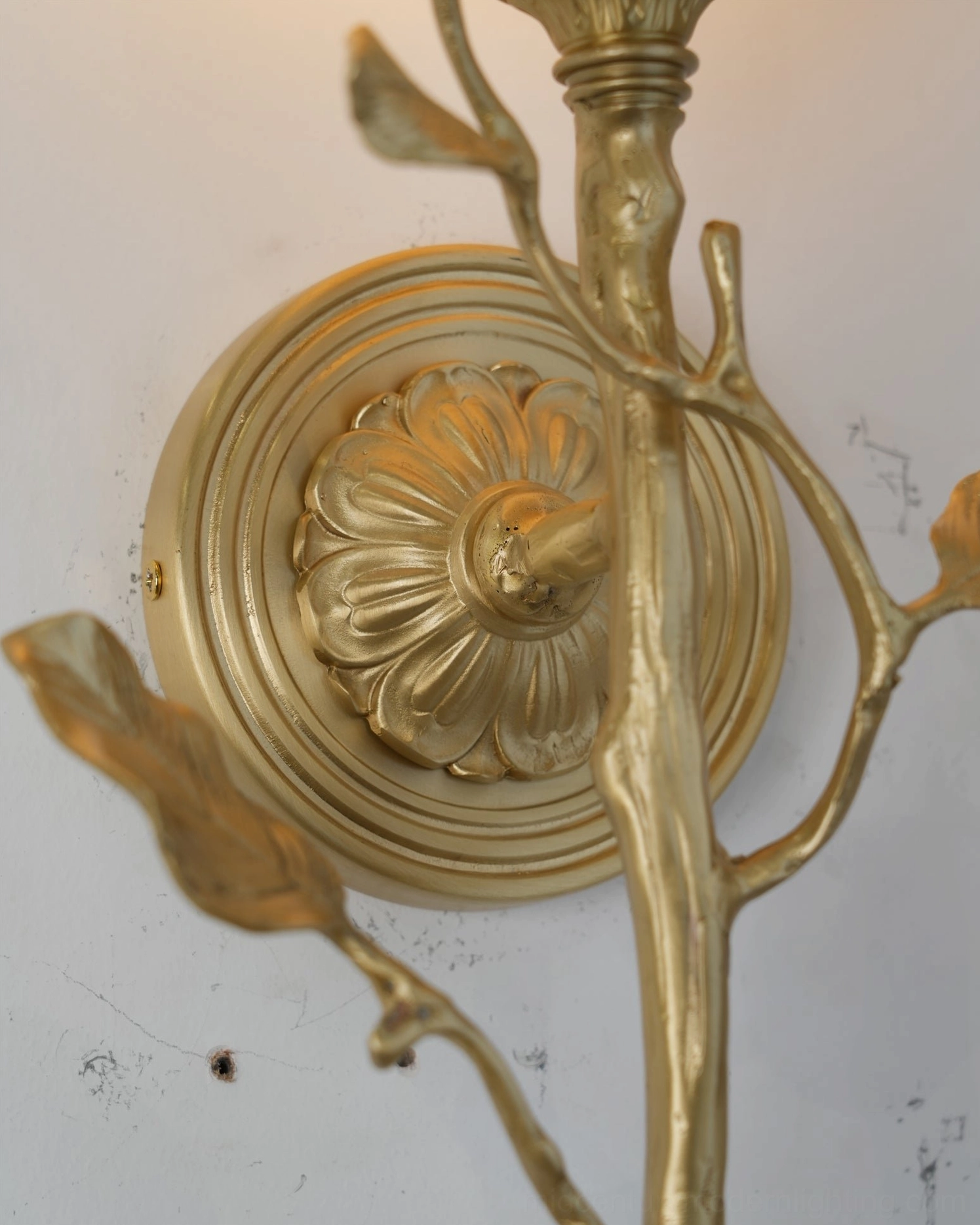 Detail view of Natalia botanical-inspired alabaster sconce showing sculptural form and light diffusion