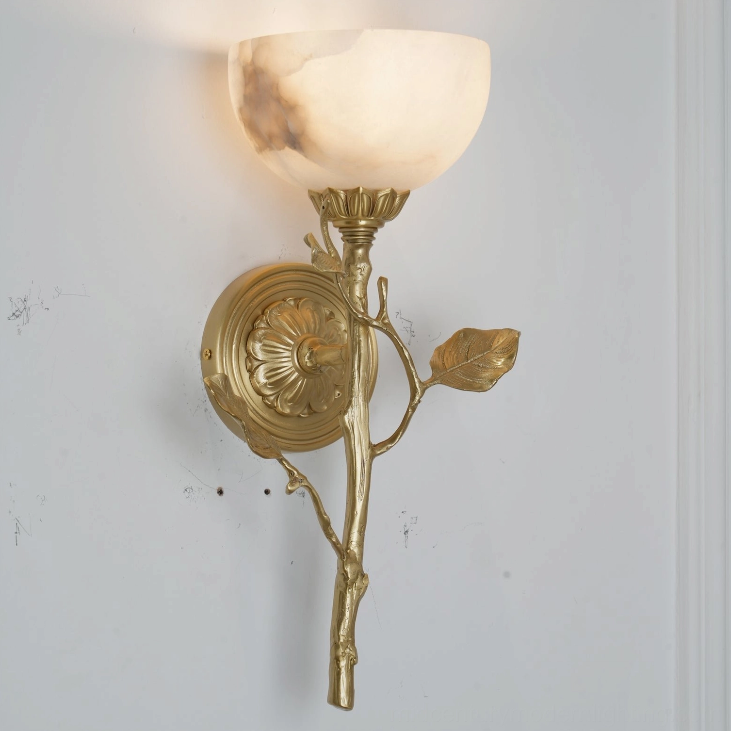Natalia floral wall sconce front view showing veined alabaster bowl shade and ornate brass carved backplate