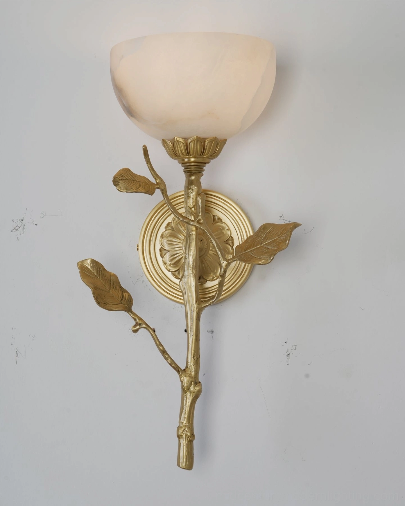 Natalia hand-carved alabaster tulip sconce showing natural stone veining and brass hardware finish