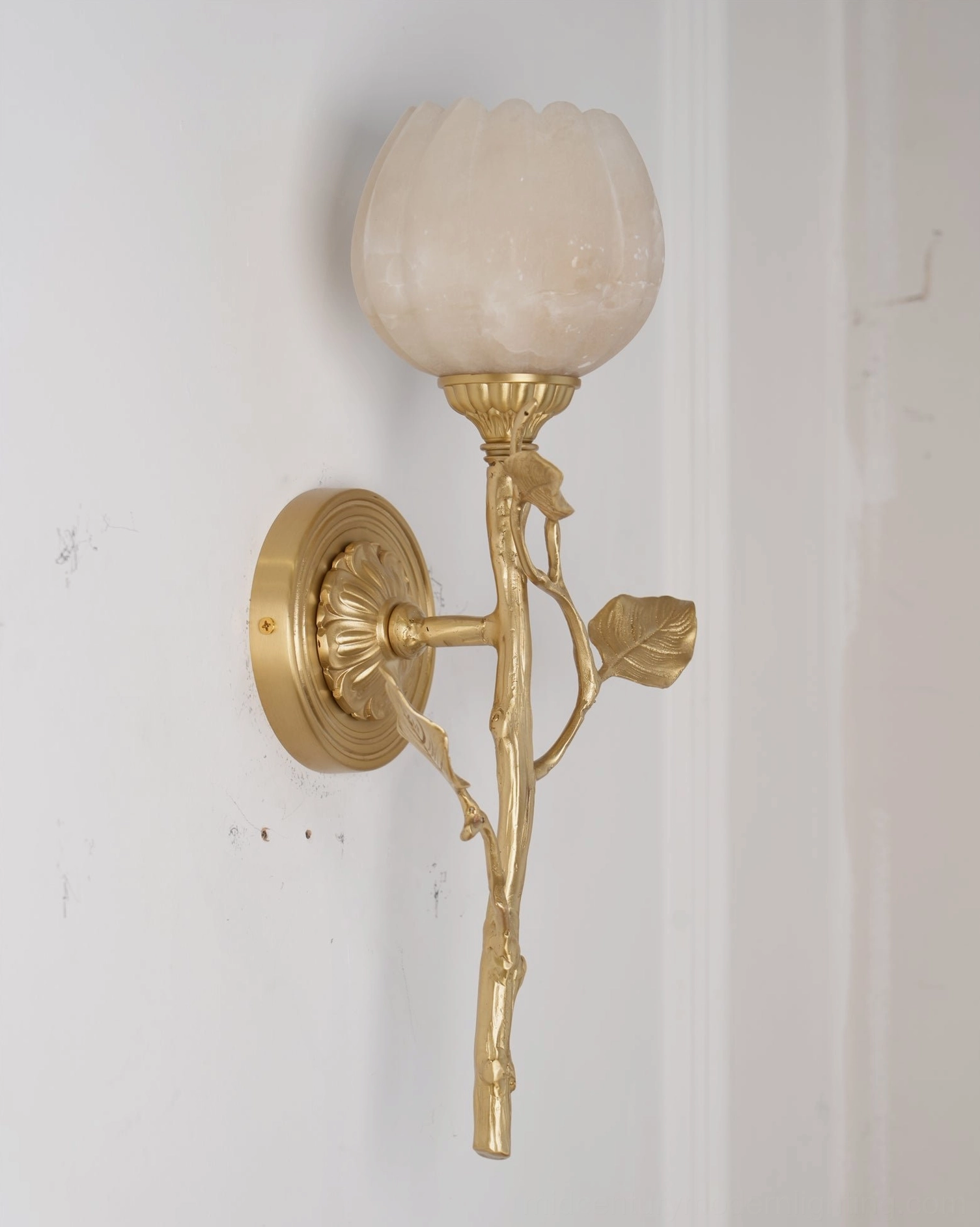 Side angle view of Natalia tulip alabaster sconce showing sculptural profile and simple brass wall mount