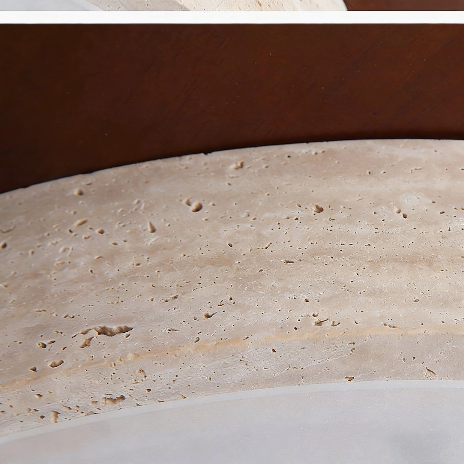 Extreme macro close-up of natural porous travertine stone texture and pitting on ceiling light trim