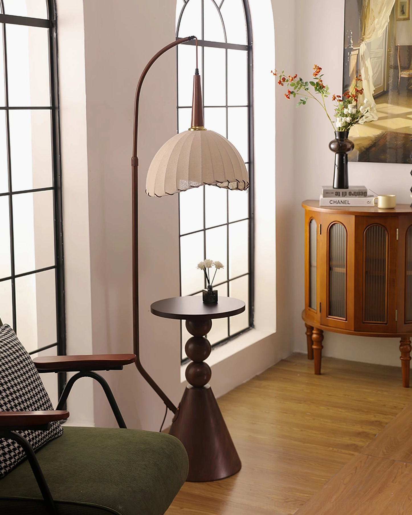 Side view of Naumy arc floor lamp with off-white pleated shade and dark wooden table base in bright vintage interior