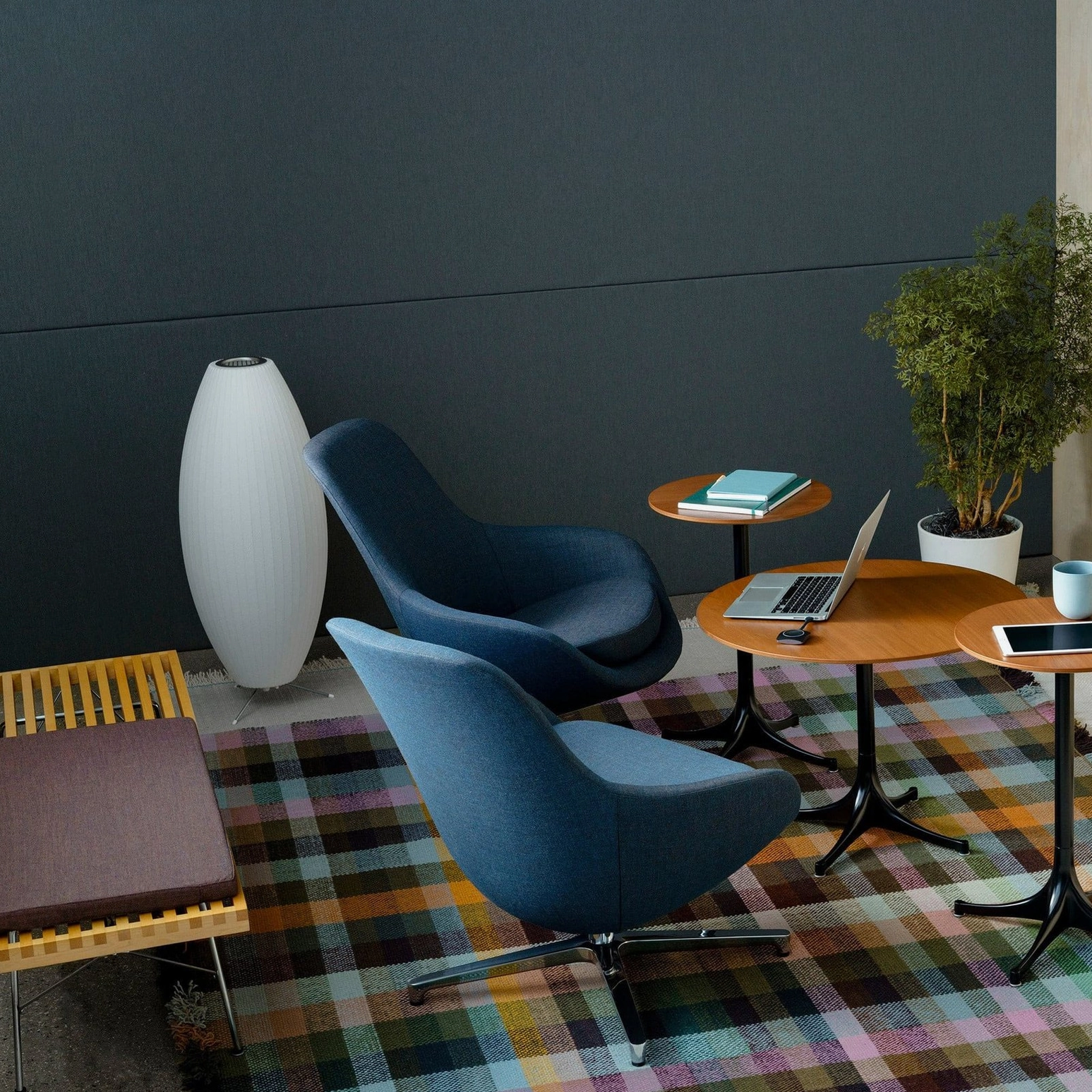 George Nelson bubble tripod lamp positioned in modern coworking environment with minimalist furniture and professional decor