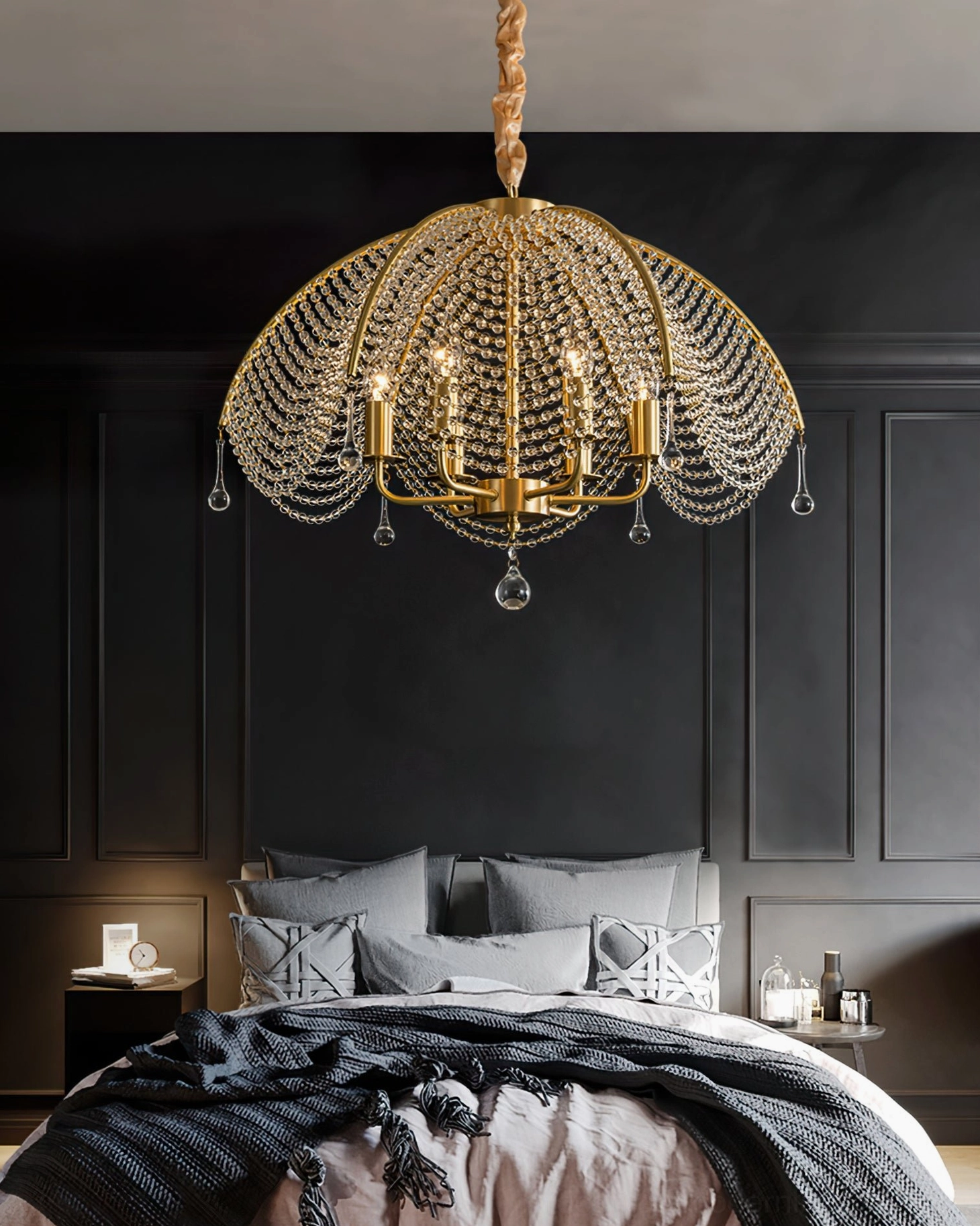 Neville crystal chandelier suspended in upscale bedroom creating romantic mood lighting over dark interior