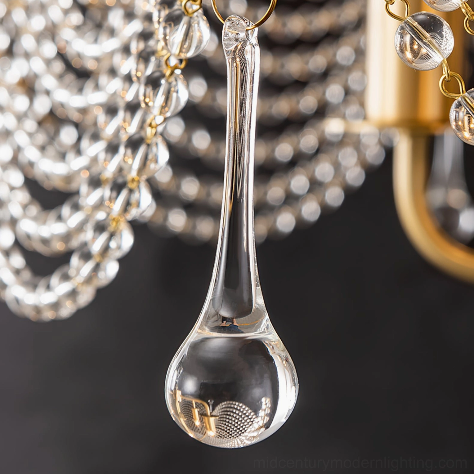 Close-up front view of Neville chandelier teardrop crystal pendant showing smooth blown glass details