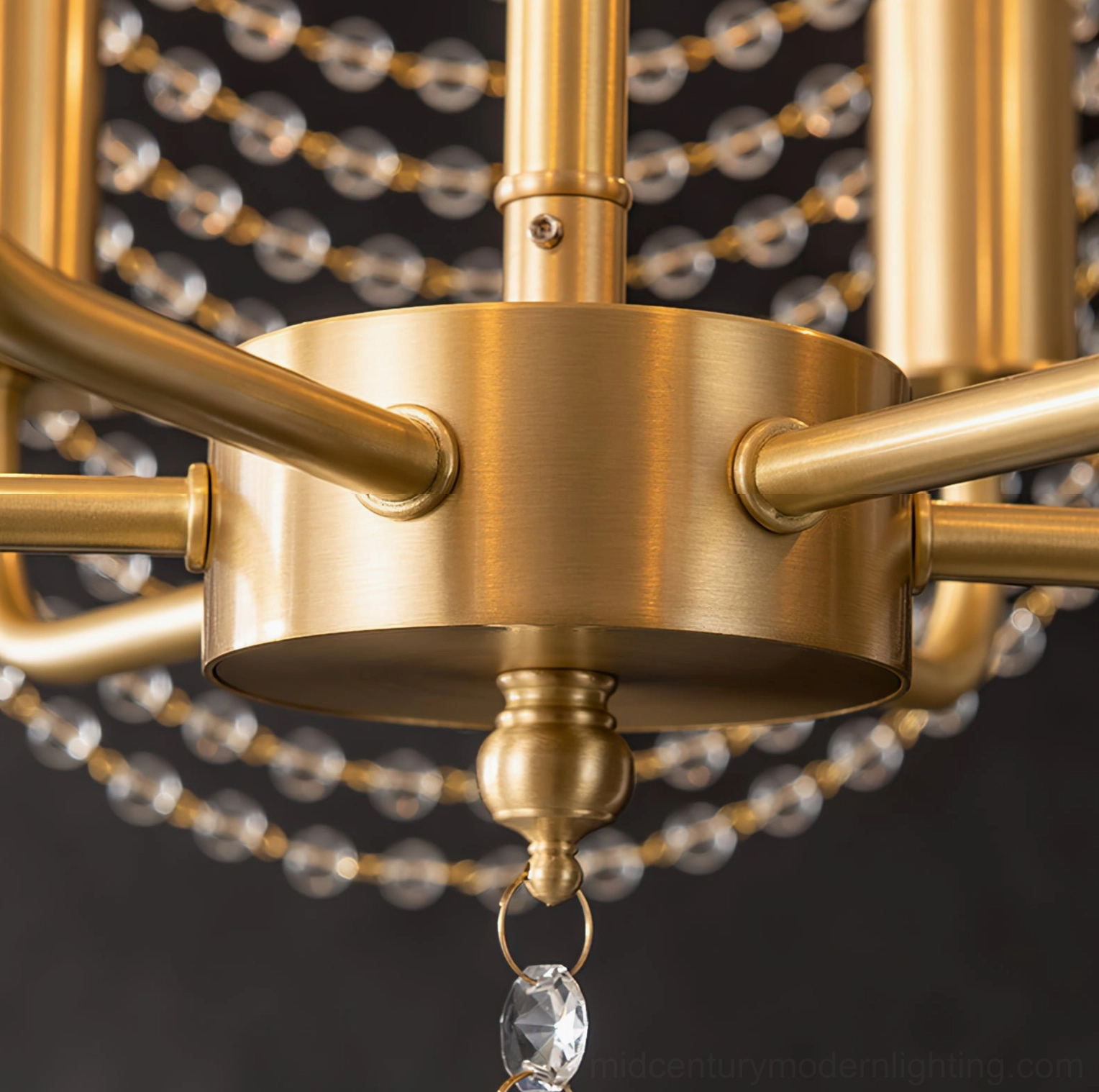 Close-up overhead view of Neville chandelier central brass fixture showing brushed finish and crystal bead attachment points