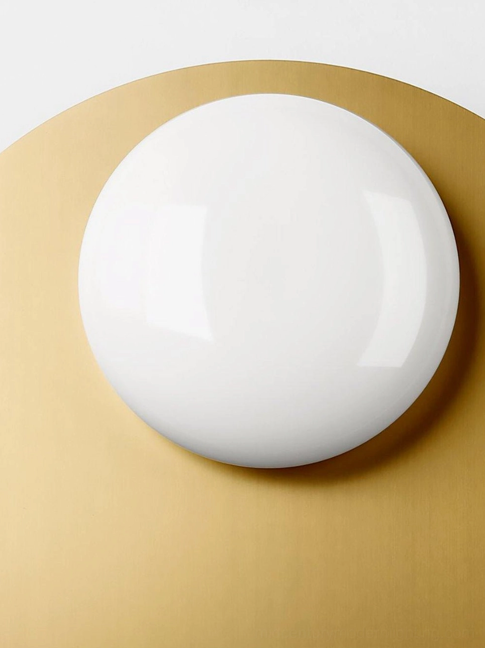 Nodes frosted white glass shade detail with brass mounting plate showing smooth borosilicate construction