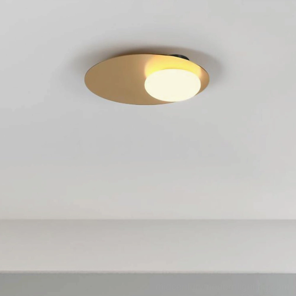 Nodes contemporary sconce with warm gold finish creating inviting ambient bedroom lighting atmosphere