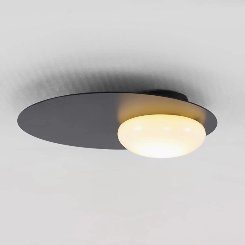 Nodes wall-mounted sconce warm gold tone with frosted white glass in bright studio lighting
