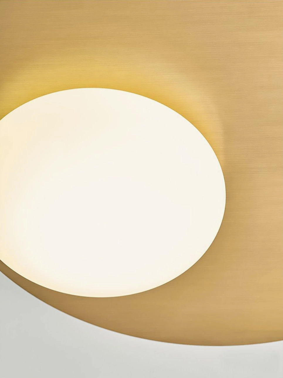 Nodes wall lamp detail showing precise brass mounting angle and frosted glass light transmission