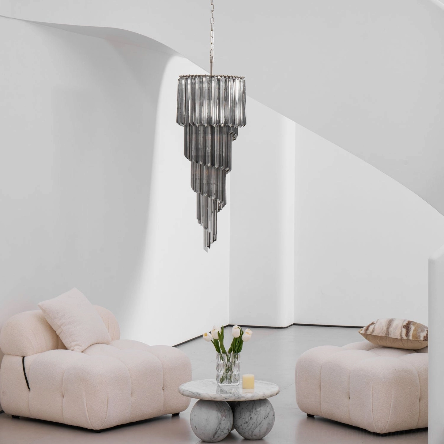 Smoke gray tiered spiral chandelier hanging in contemporary loft space, side profile architectural view