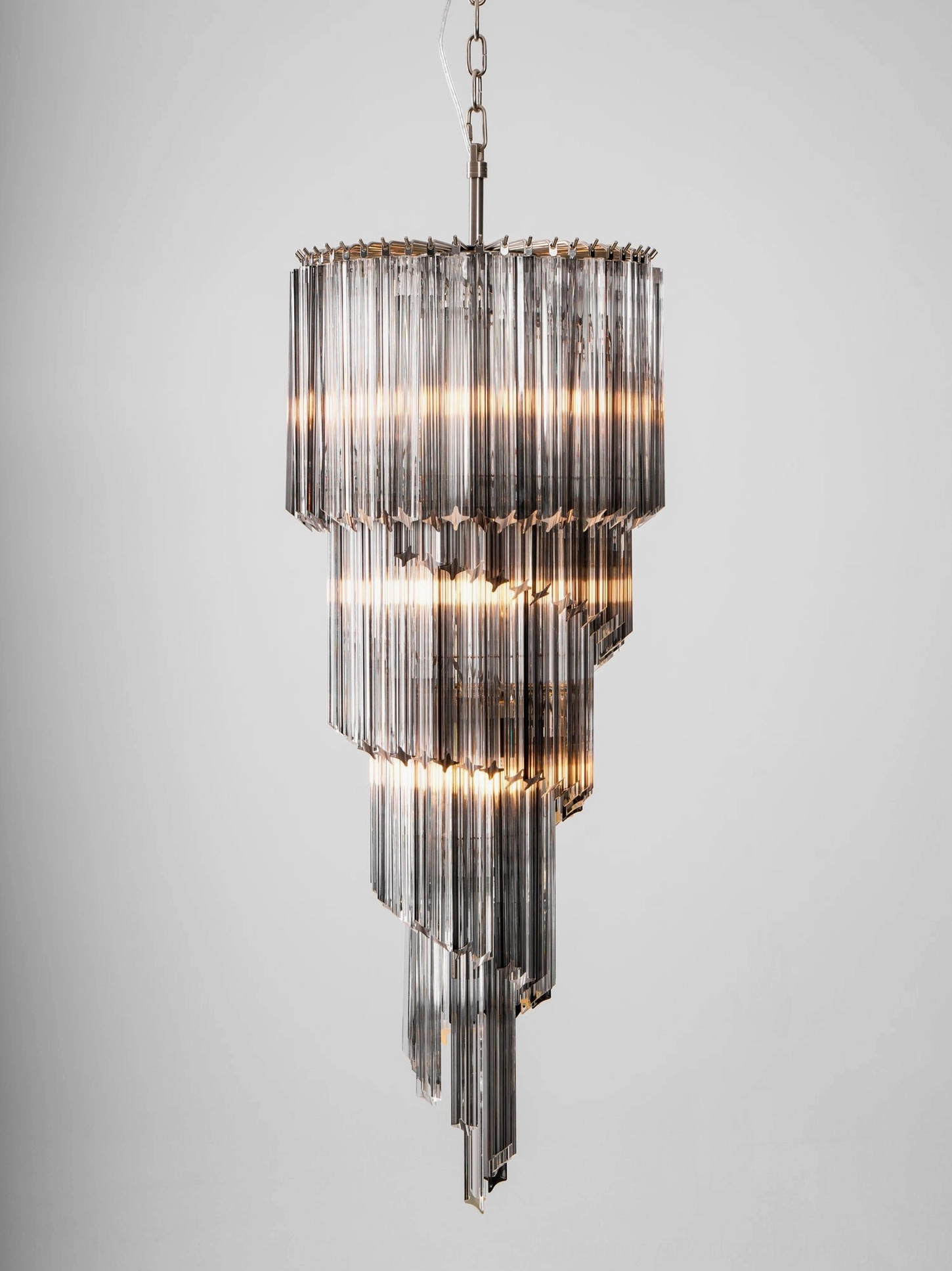 Noir cascade chandelier in minimalist interior, demonstrating mid-century modern aesthetic and shadow play