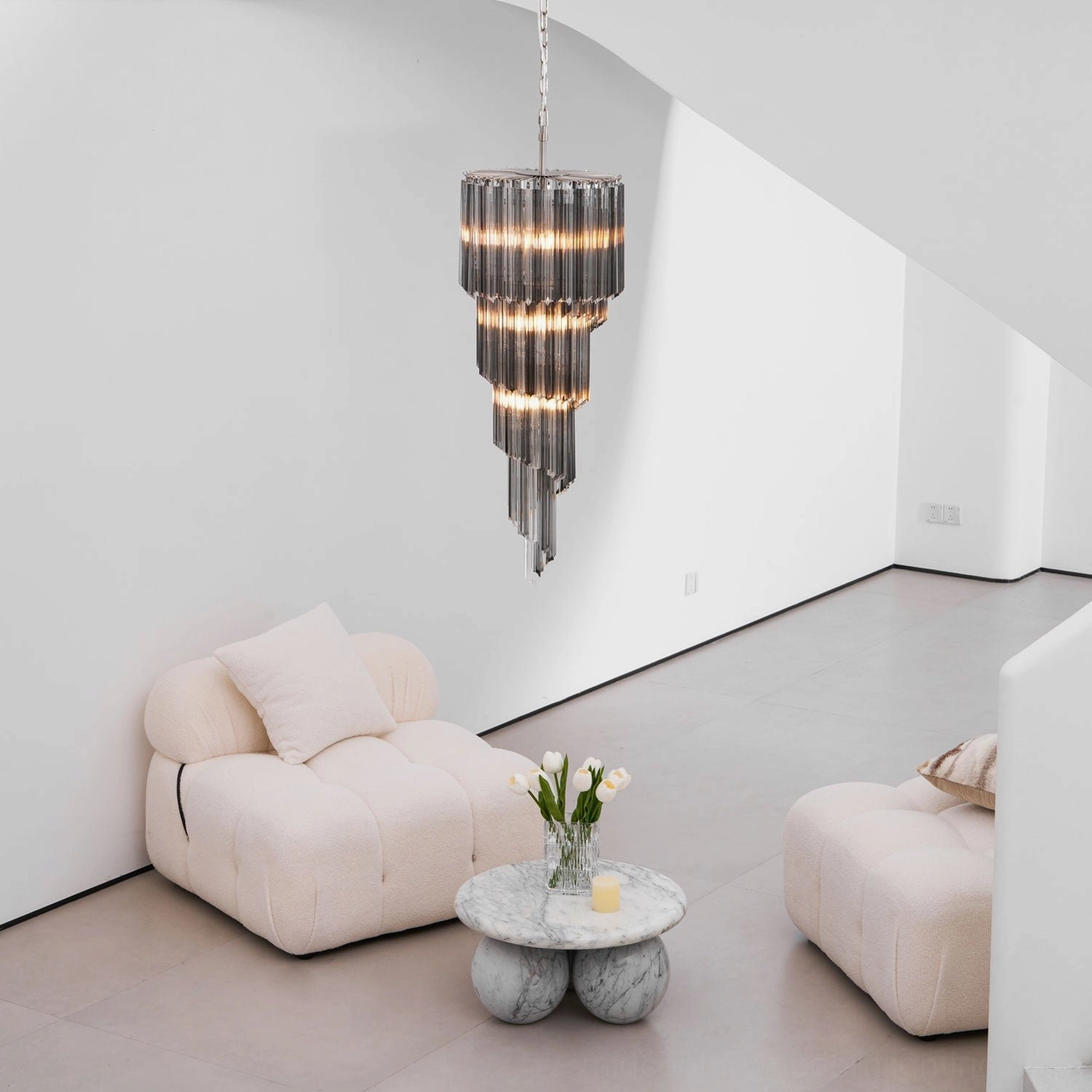 Modern spiral glass chandelier cascade in minimalist white narrow room, layered smoked glass structure detail