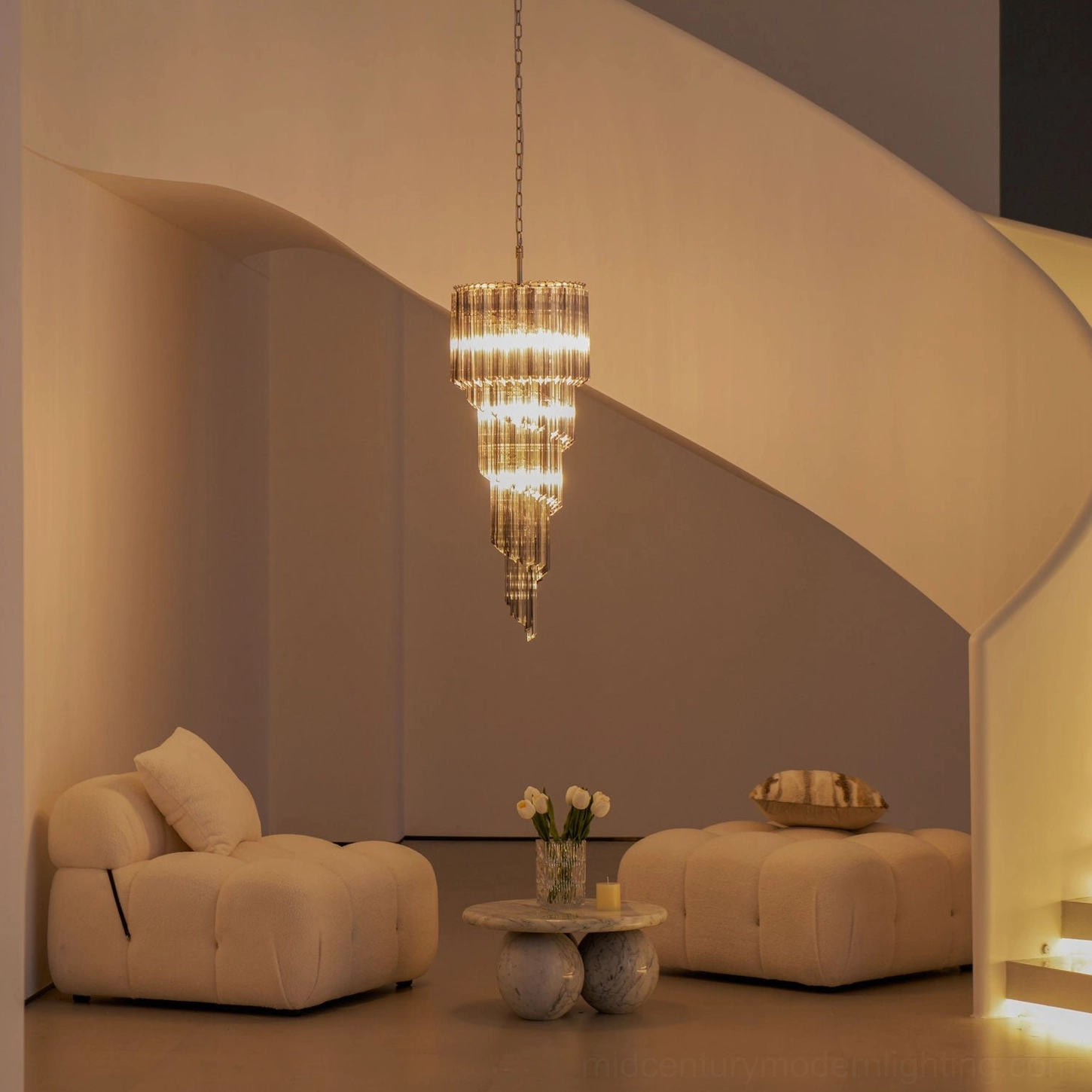 Architectural view of spiral glass chandelier cascade demonstrating vertical space transformation