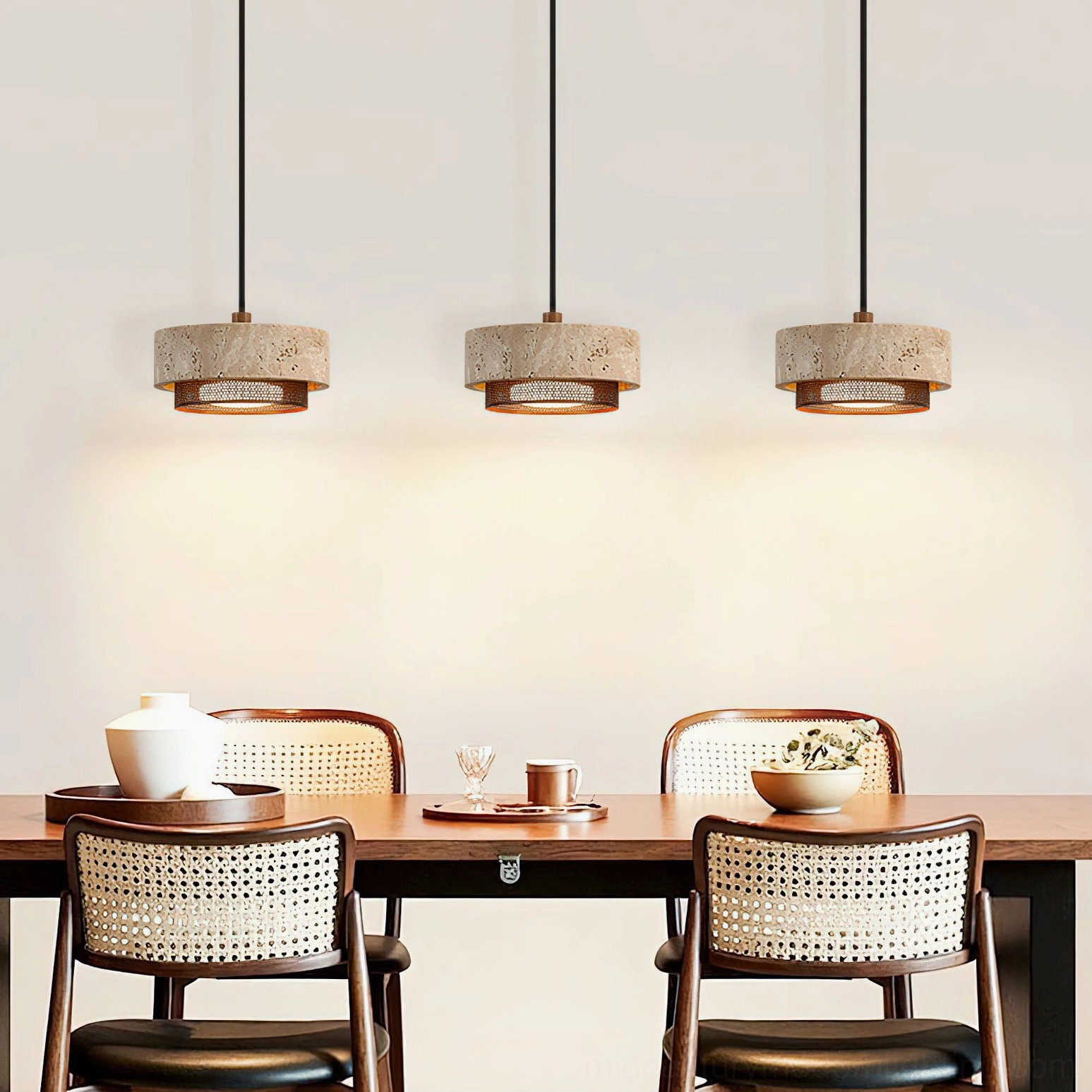 Three-light Nolan pendant configuration installed linearly above modern dining table with wooden surface, creating warm pooled lighting