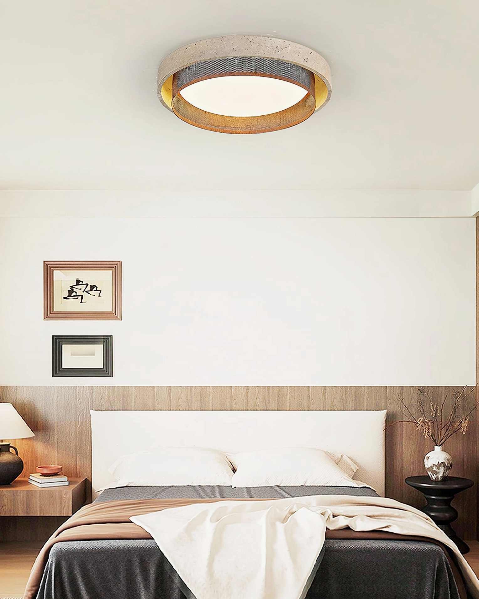 Modern travertine flush mount light in compact bedroom with dark linens and warm accent lighting