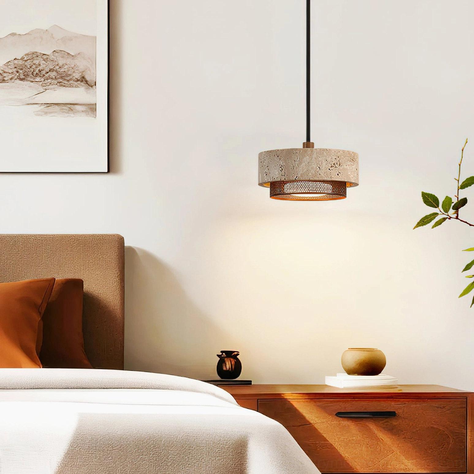 Single Nolan pendant hanging in modern bedroom with wooden nightstand and neutral bedding, warm stone light fixture