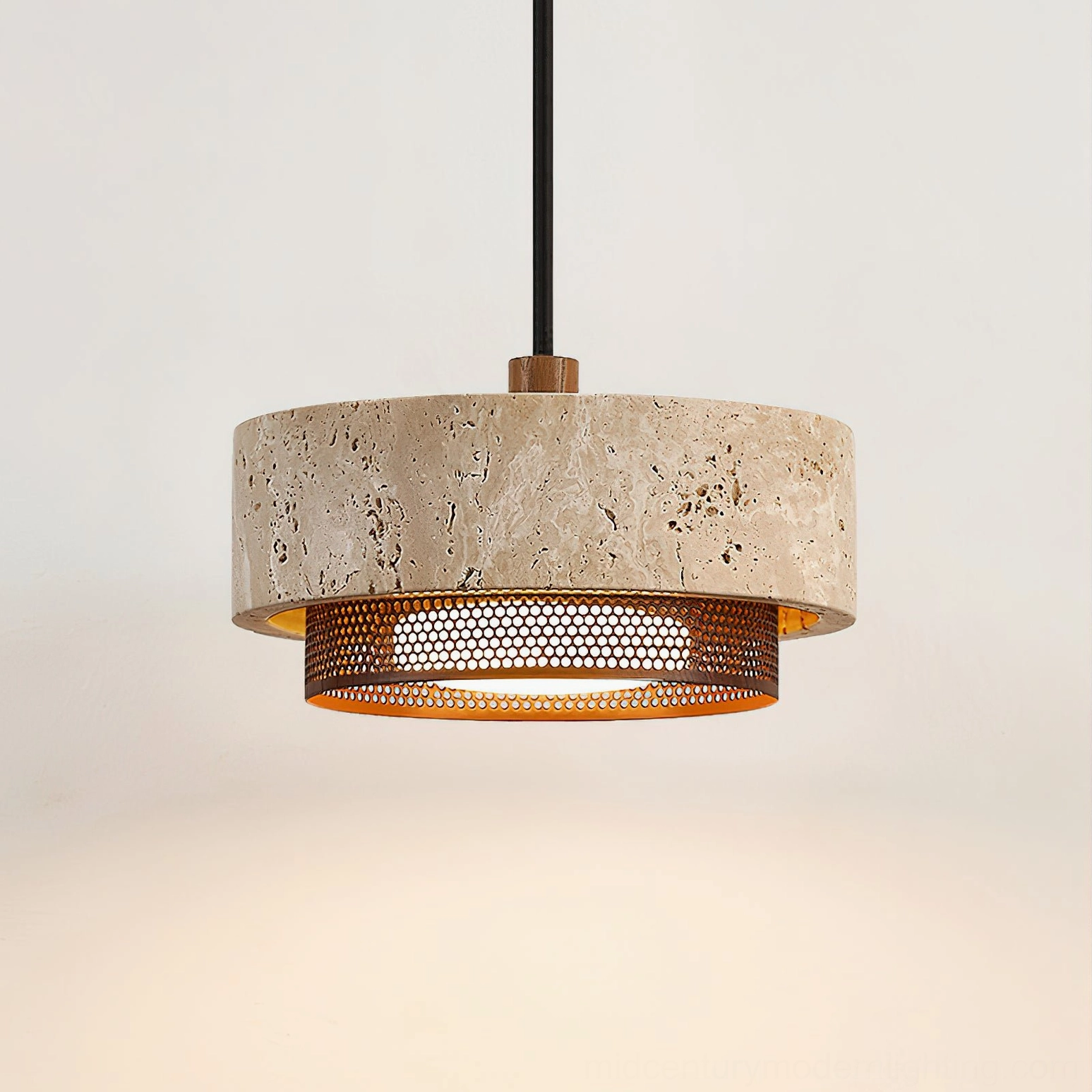 Close-up detail of Nolan pendant light showing porous travertine surface, warm beige veining, and perforated bronze trim ring