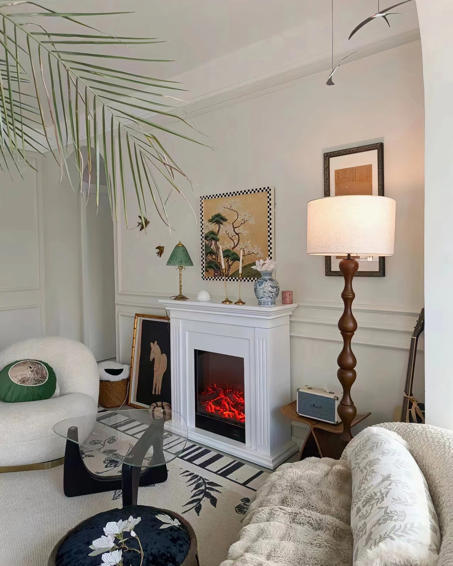 Norden sculptured wooden floor lamp in bohemian eclectic room with plants and global decor