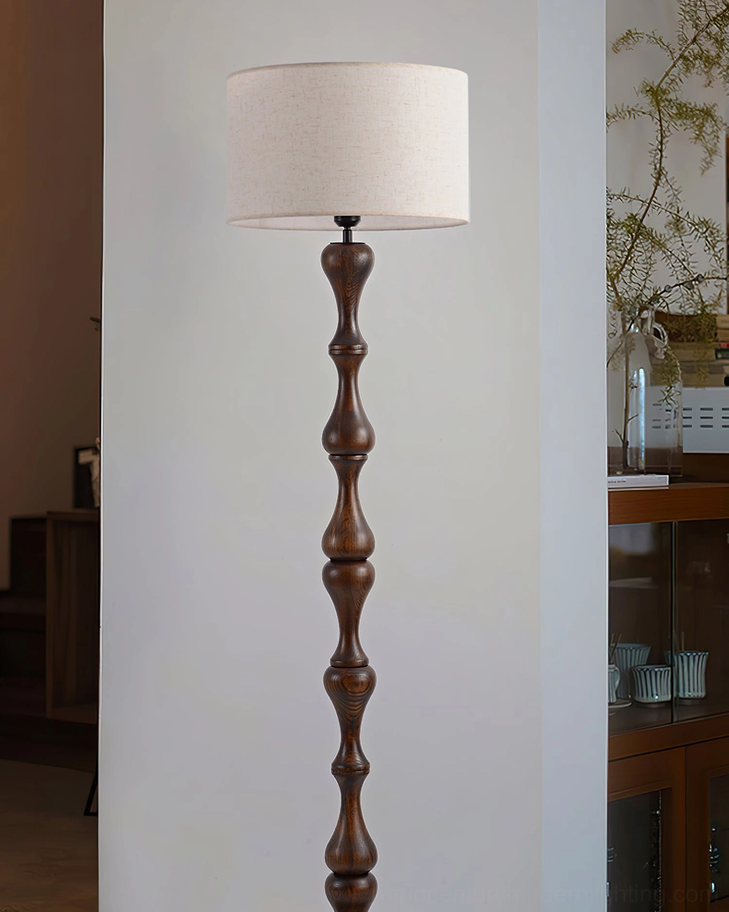 Norden carved wood floor lamp in home office setting, perfect ambient light for reading and work