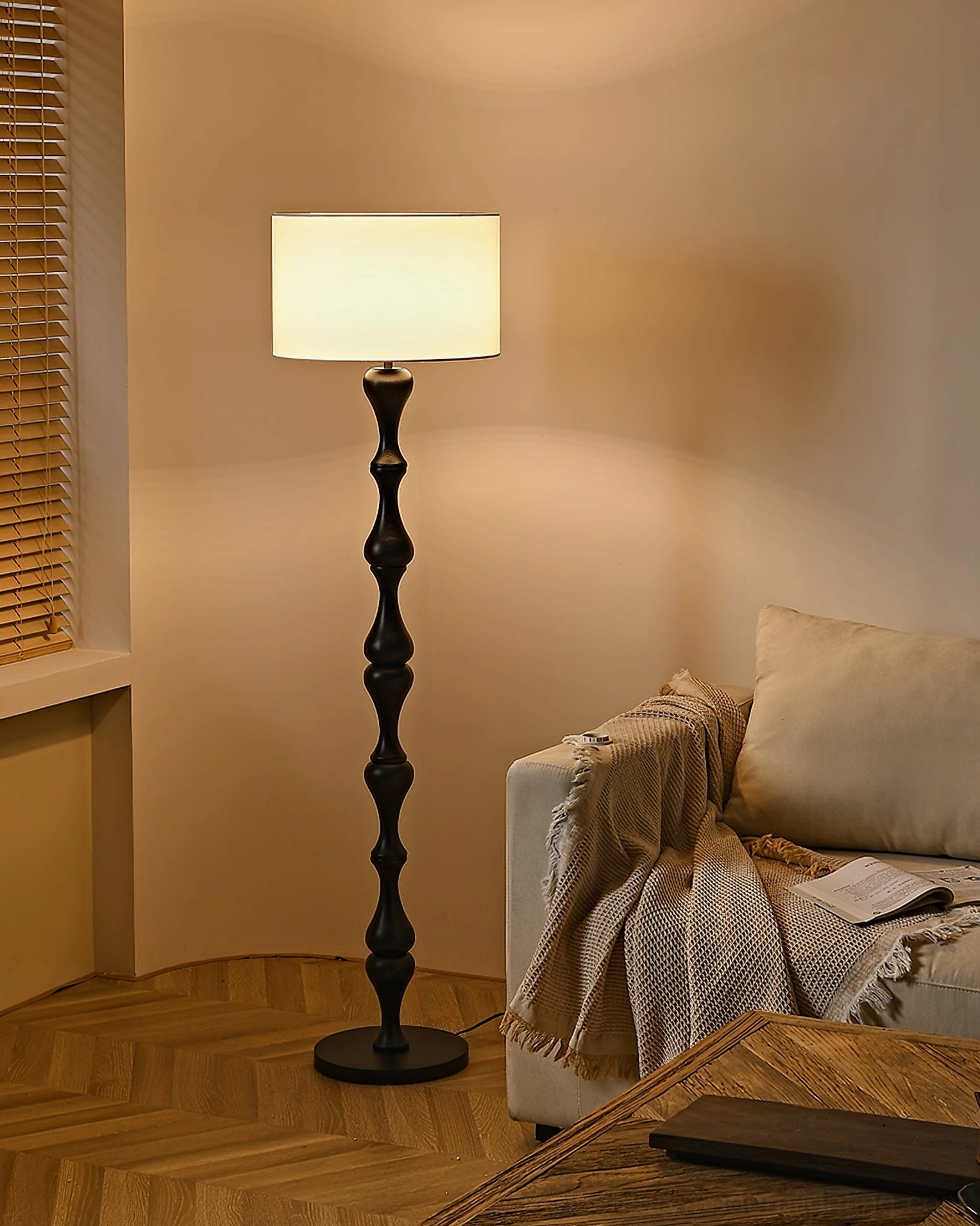 Norden mid-century modern standing lamp with artistic carved wooden pole in studio setting