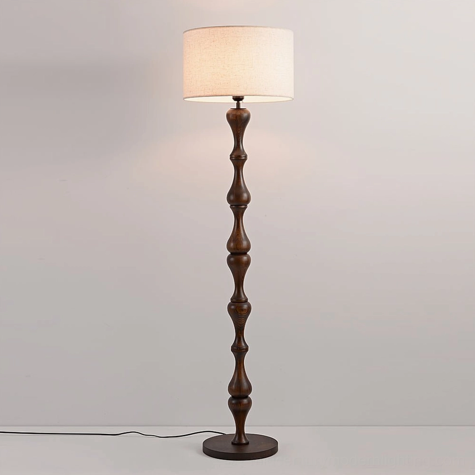 Norden mid-century modern floor lamp walnut color with sculptured wooden pole on neutral background