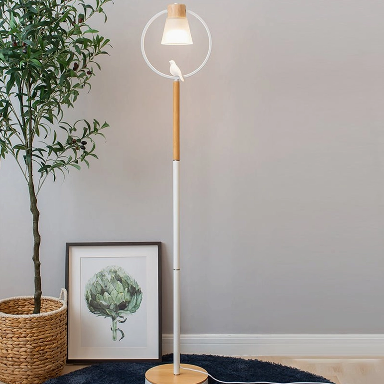 Scandinavian floor lamp arc design styled with potted plant and wall art in contemporary home decor