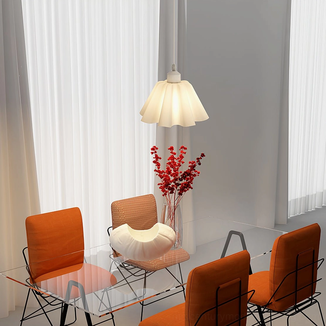 Nordic pleated pendant lamp above glass dining table with warm terracotta accent chairs in scandinavian interior