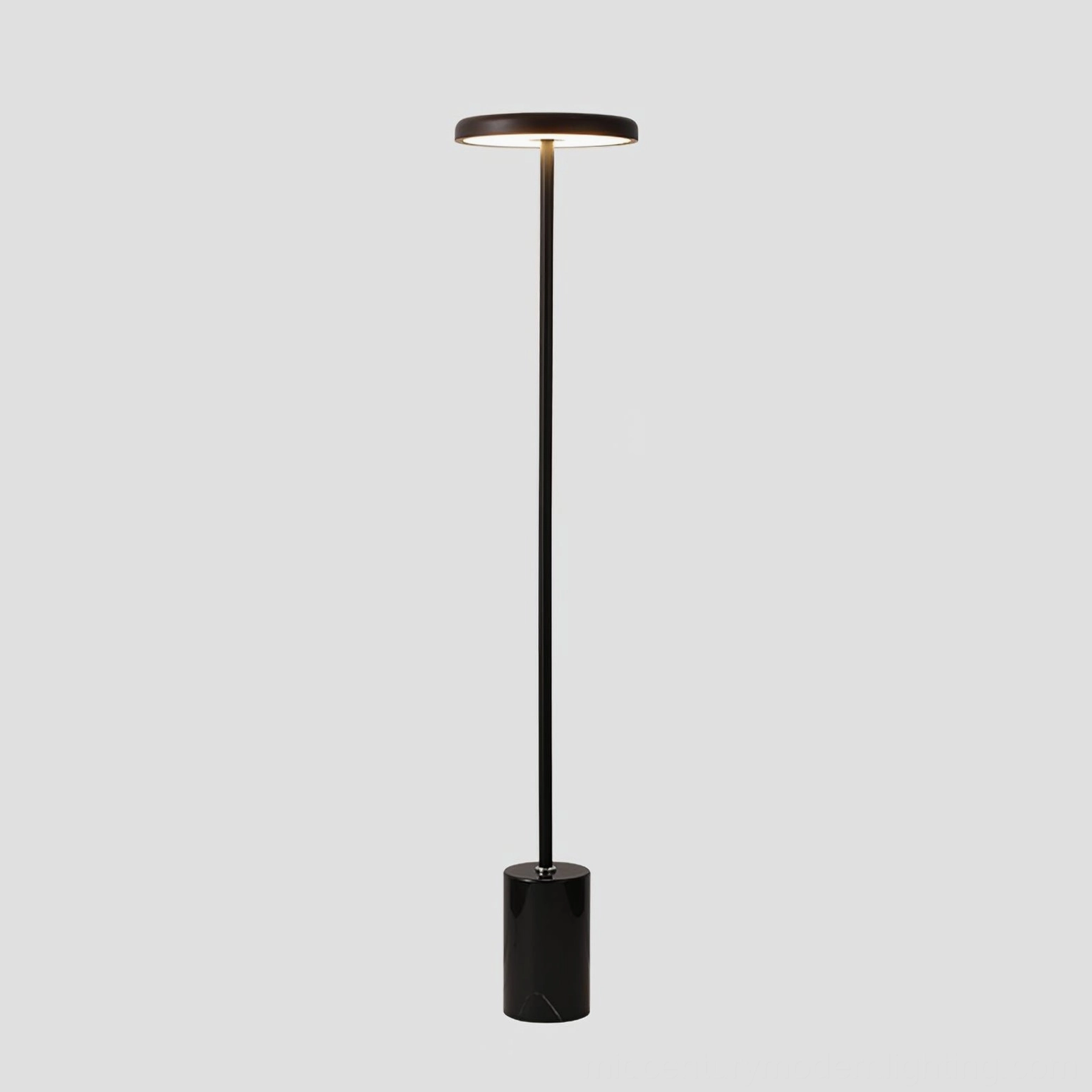 Modern minimalist floor lamp, all-black metal finish with sculptural angular design, contemporary lighting on white background