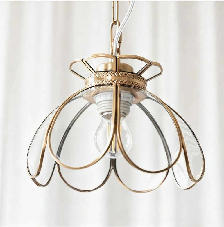 Odette lotus glass pendant light in clear glass with visible bulb and decorative brass canopy, single fixture view