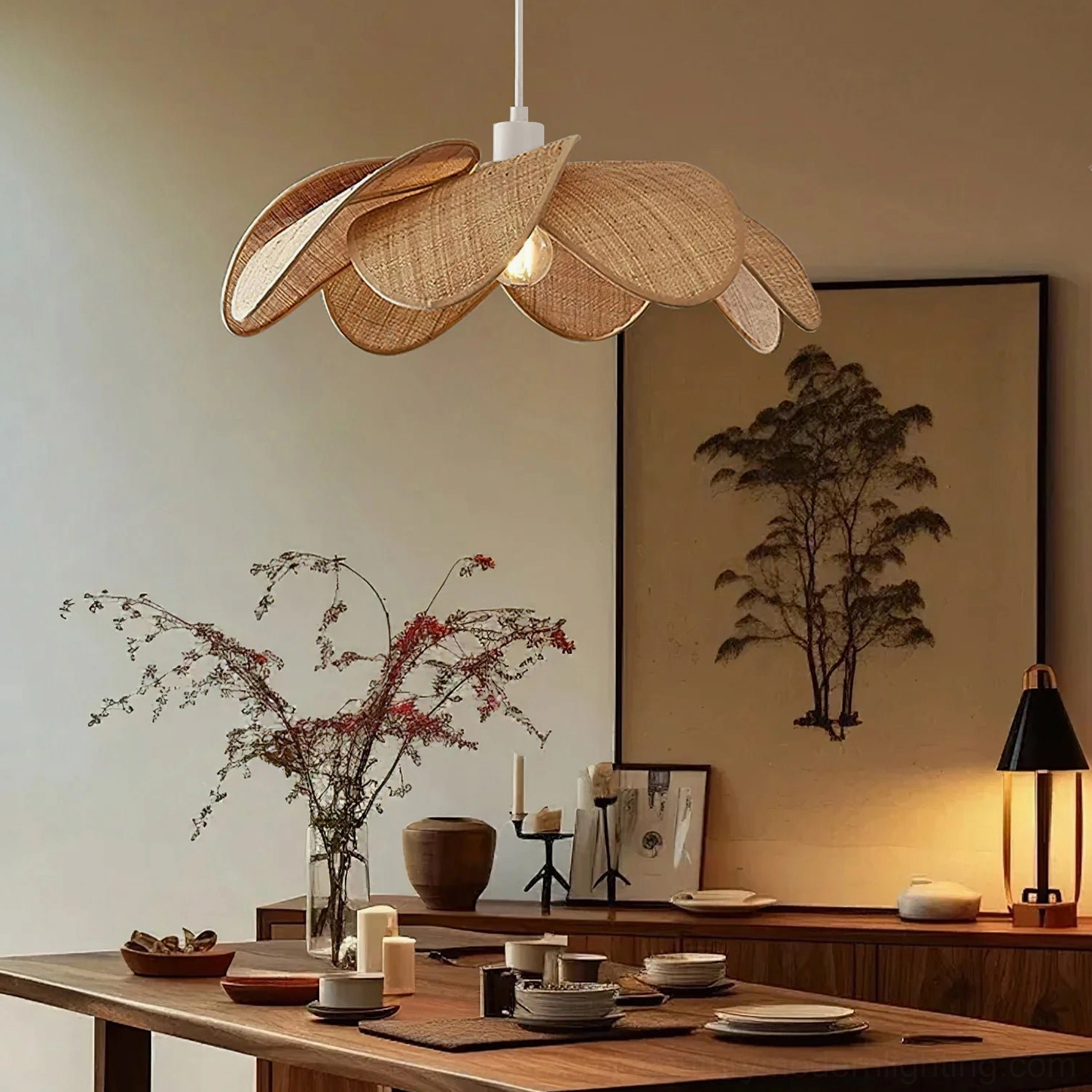 Odilia rattan pendant light above wooden dining table, japandi wabi-sabi interior style, low front view showing shadow play through woven structure
