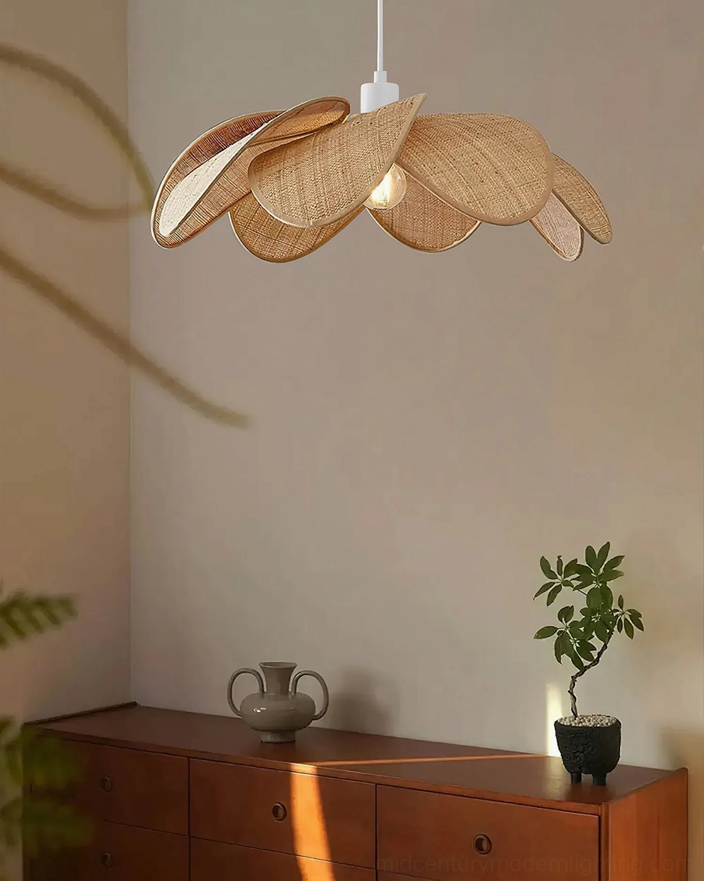 Odilia rattan pendant light in entryway with wooden side cabinet, warm rustic wabi-sabi style, side front view showing architectural fixture design