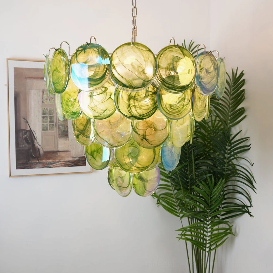 Olive green glass disc chandelier with blue accents and tiered design in mid-century modern home setting, three-quarter view