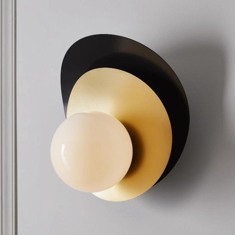 Olivia wall sconce black and brass finish with frosted glass globe front view showcasing minimalist sculptural design