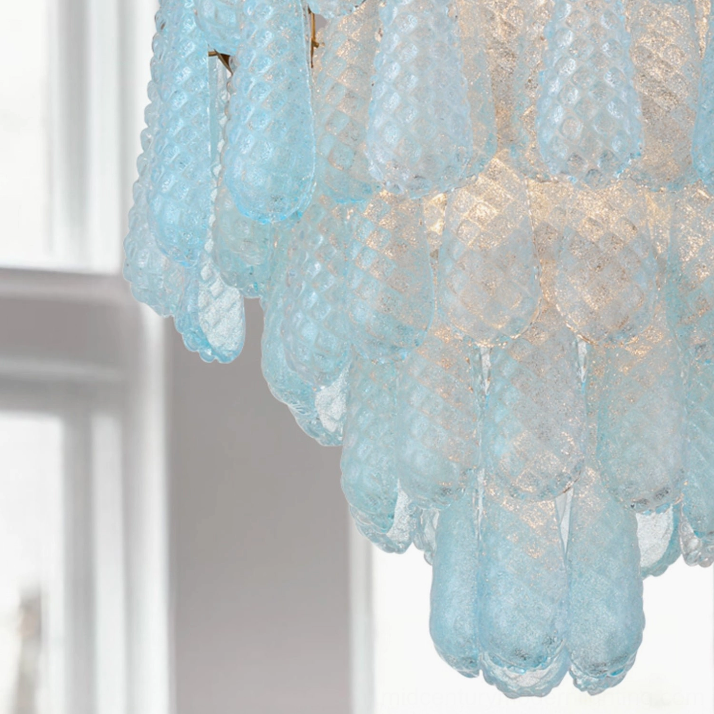 Close-up macro view of Ollie light blue textured frosted glass teardrop shade with natural light refraction