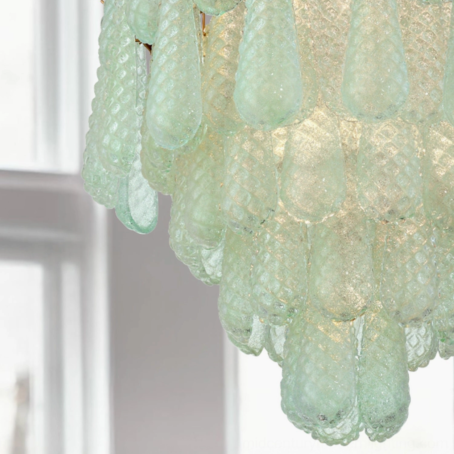 Close-up macro view of Ollie chandelier mint green textured frosted glass teardrop shades with light diffusion
